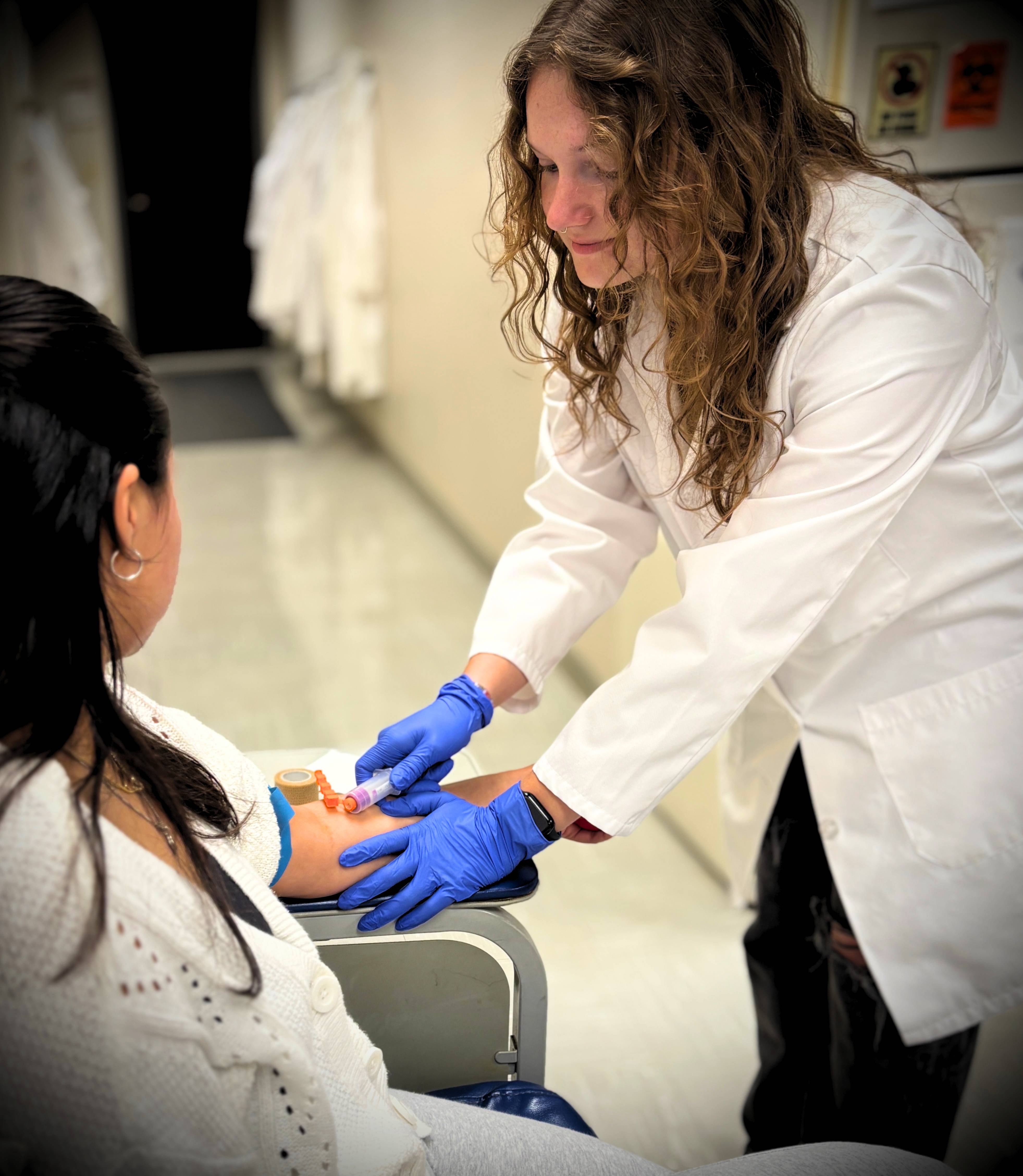 Student helping patient