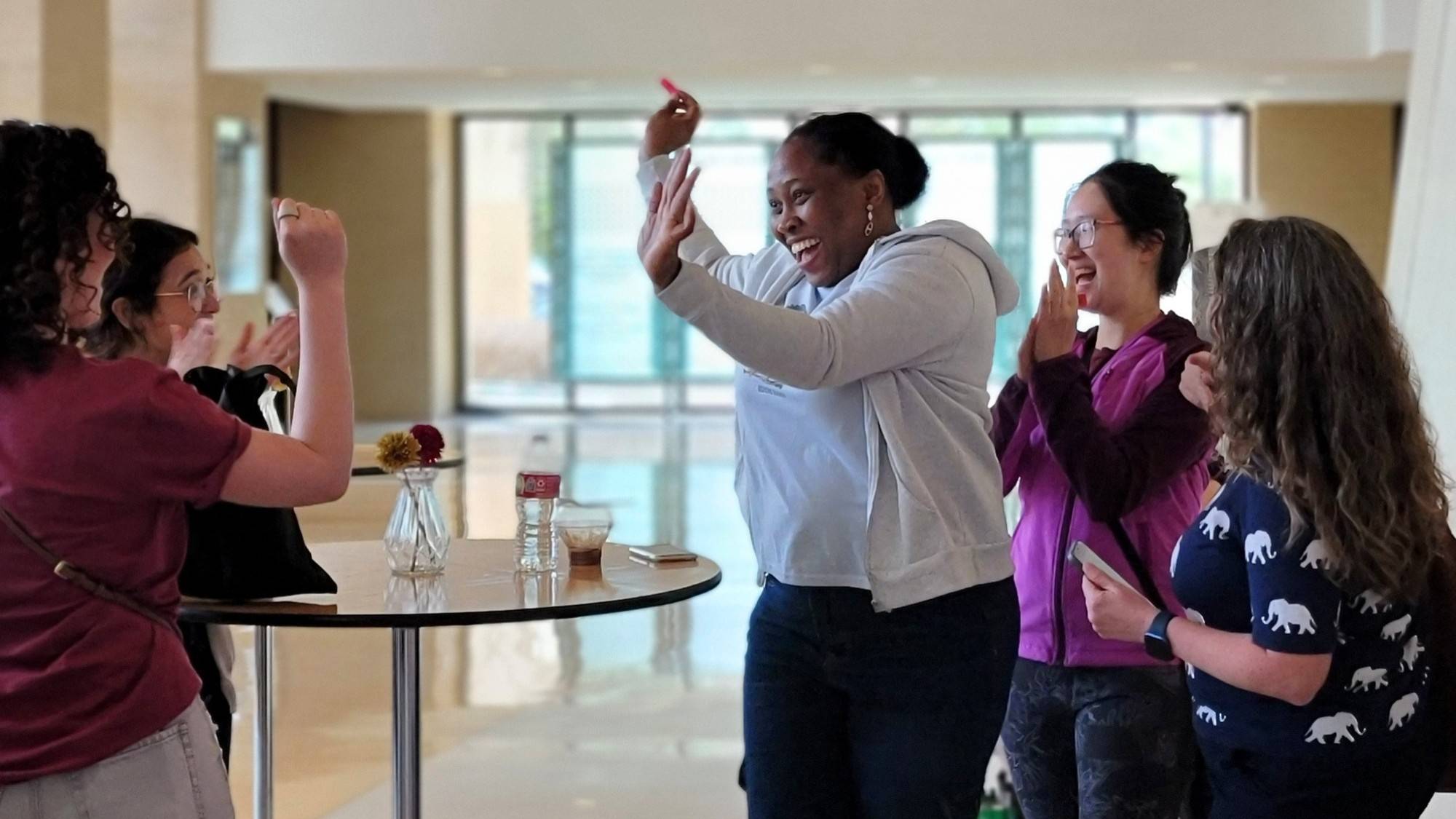 candid shot of a student celebrating winning a raffle prize with the ticket in her hand