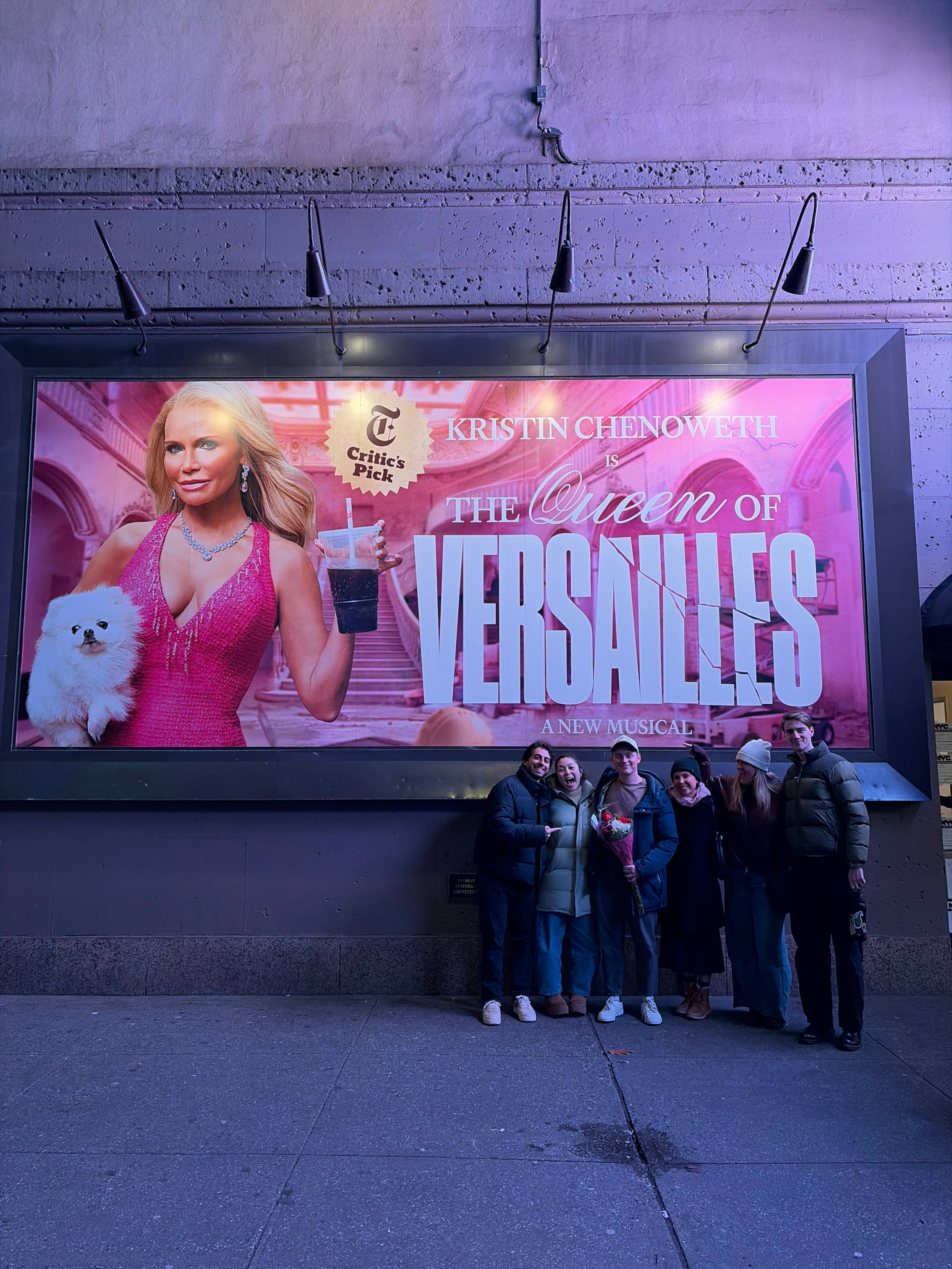 Jake Young and family members pose for a photo next to a large billboard for The Queen of Versailles 