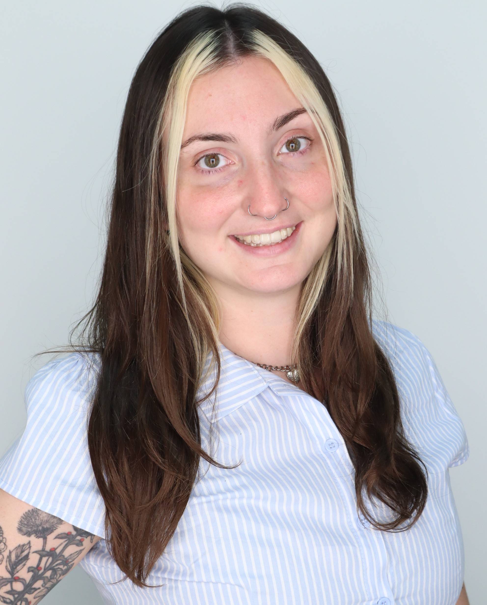 young woman wearing a white shirt smiling at camera