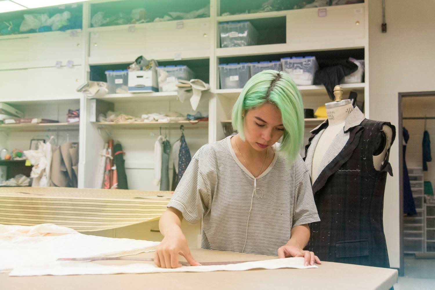 Student working on a project with textiles
