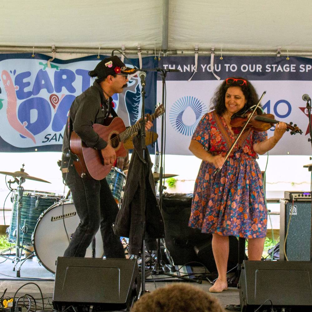 Musicians on the Ozarka Spring Water Stage at Earth Day San Marcos 2025
