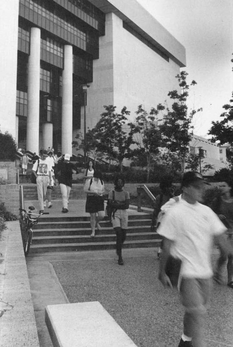 A black & white picture of people outside the alkek