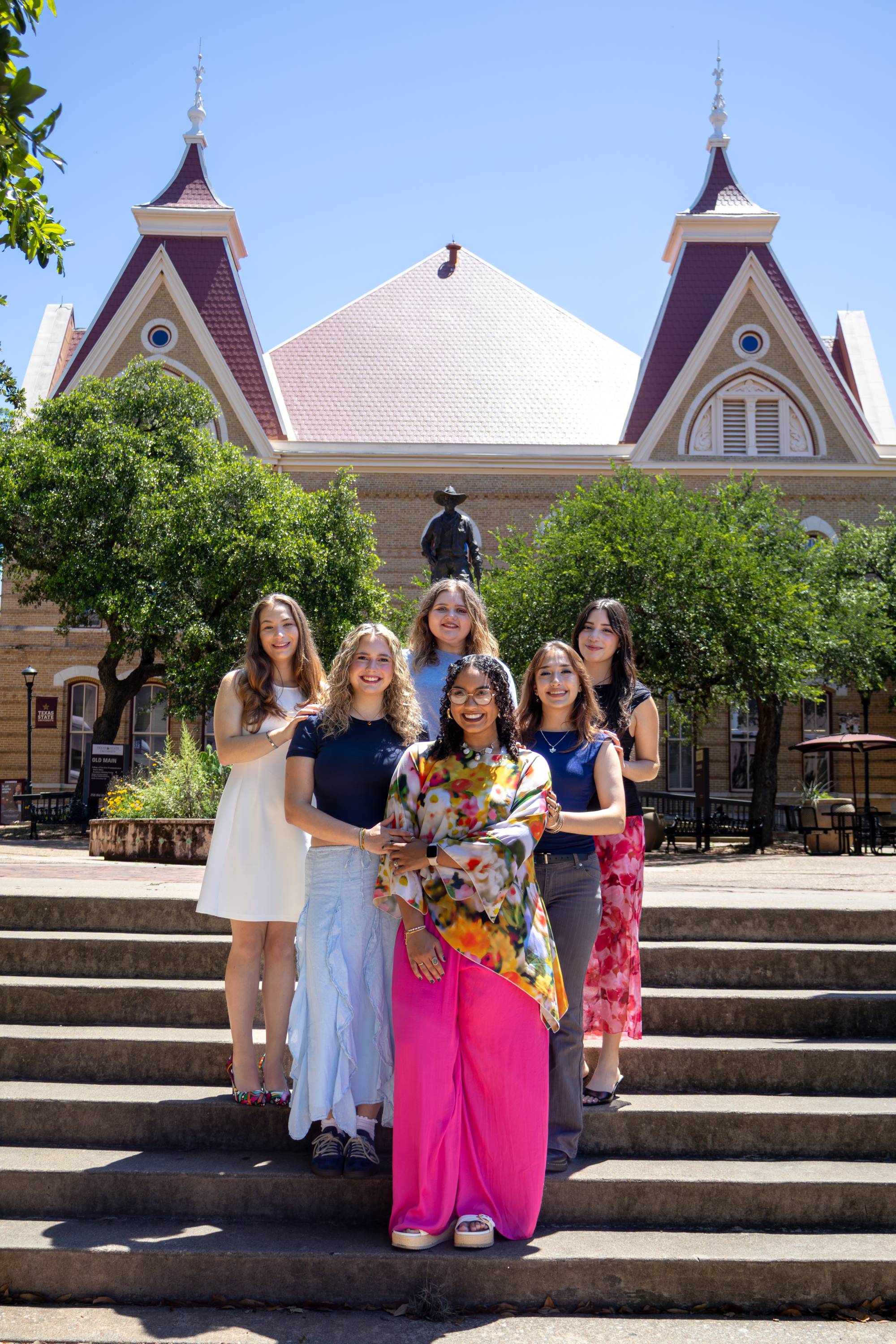 group of 6 women stand on stair for group photo