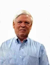 Dr. Robert  in light blue shirt against plain background