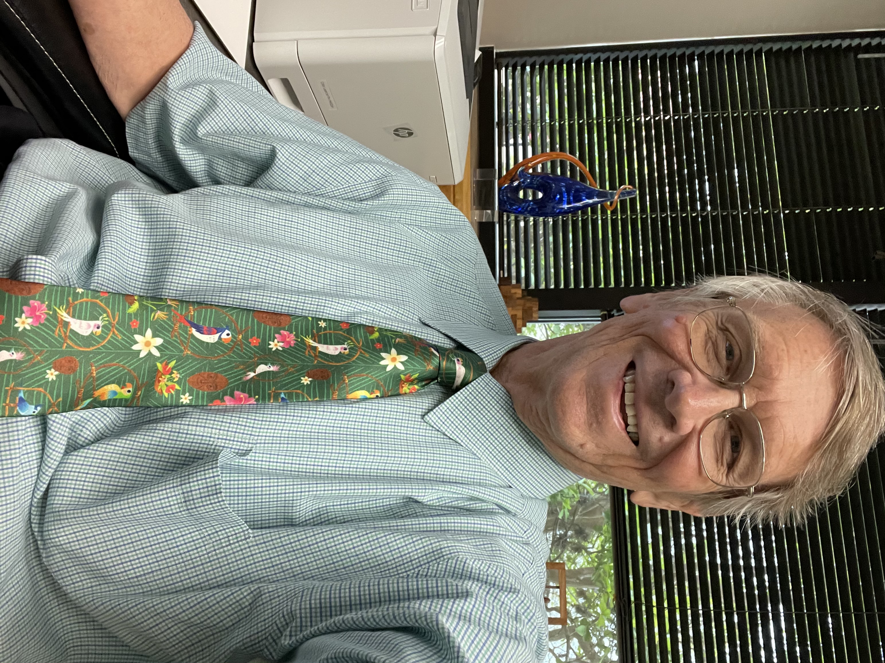 Dr. Passty with glasses sitting in office wearing patterned tie