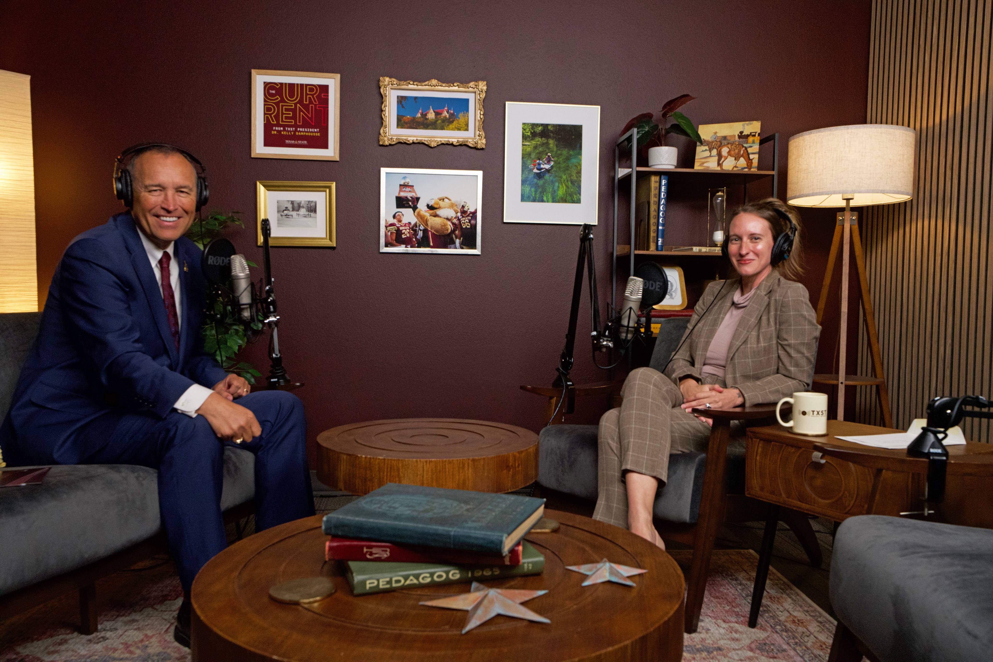 president kelly damphousse and Dr. Joann Doering Zadrozny seated in chairs while wearing headphones