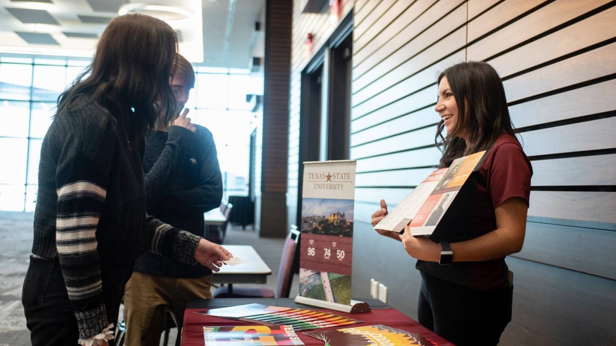 a student speaks with a department representative about a program