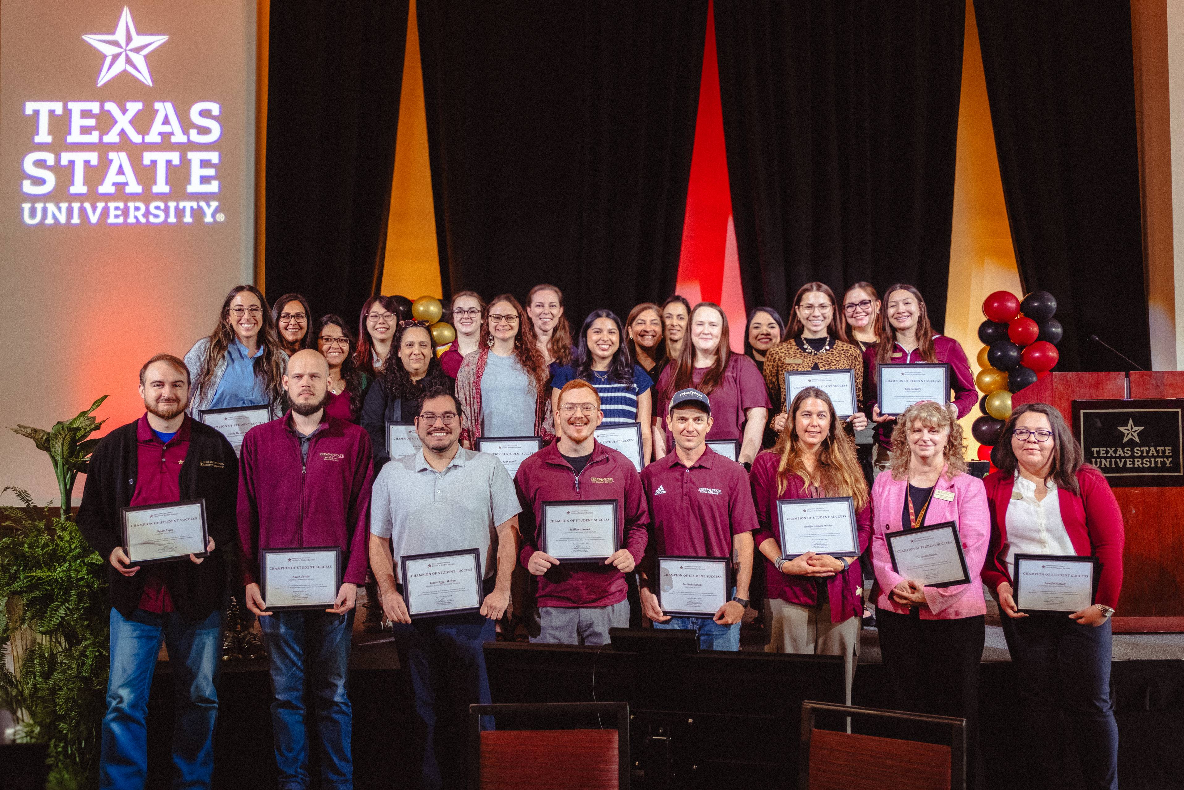 group of award recipients holding their certificate of achievement 