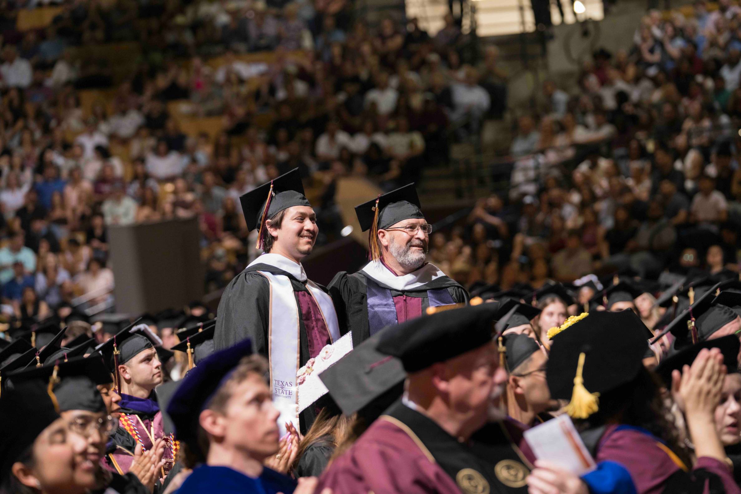 jeff and tyler stand at commencement