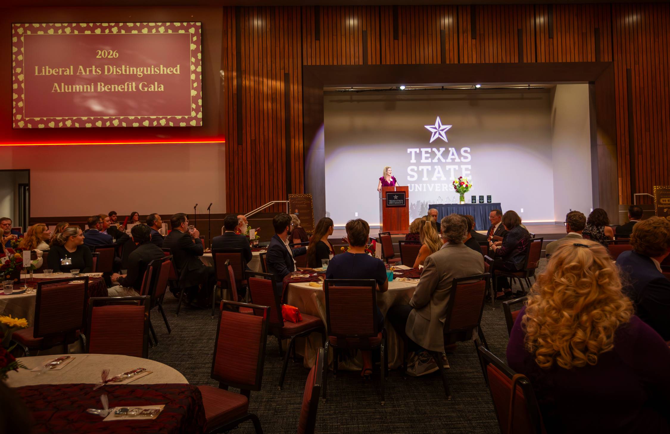 Overview of the Alumni Gala, audience attentive to speaker on stage
