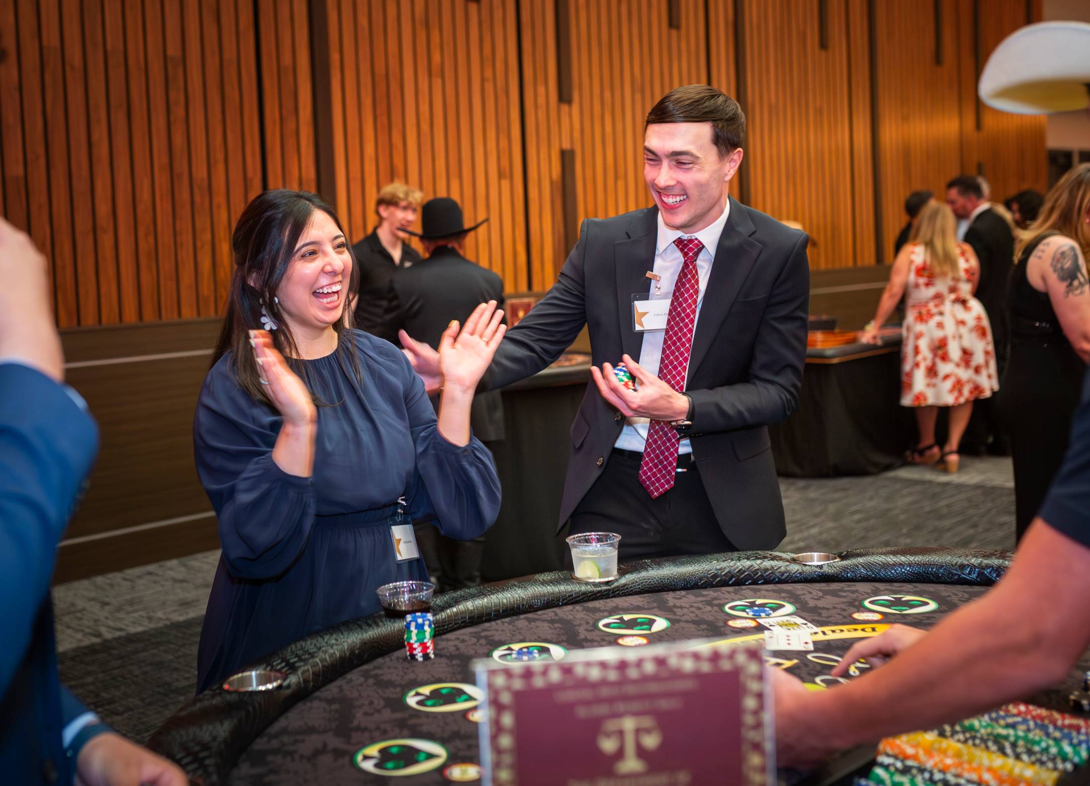 Lady in blue dress smiling at a casino table