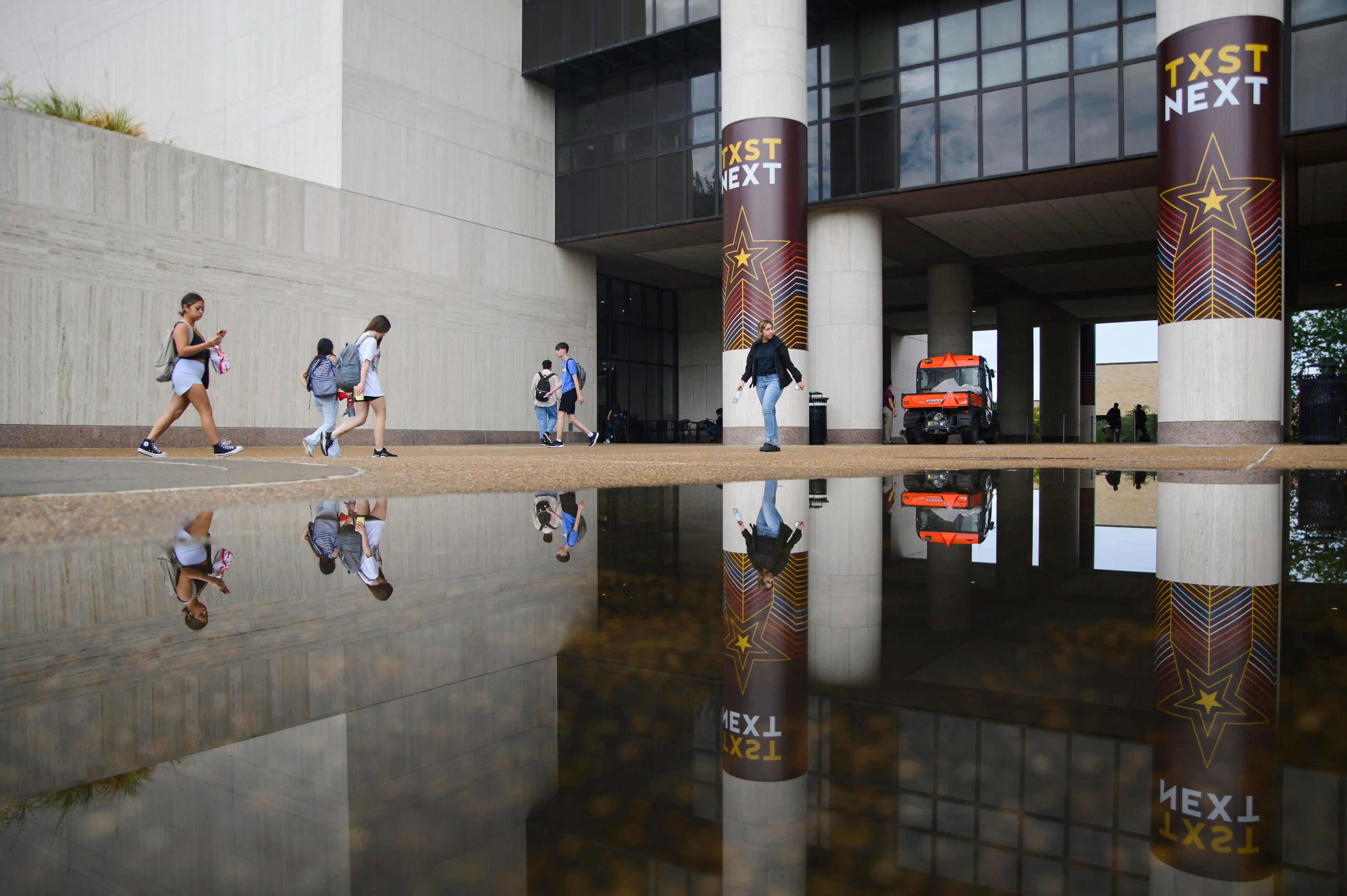 Alkek Library with puddle mirror view