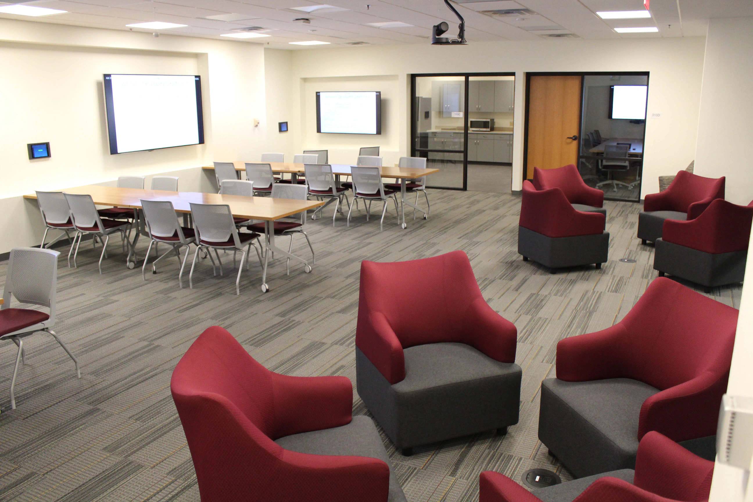 space with chairs and big screens