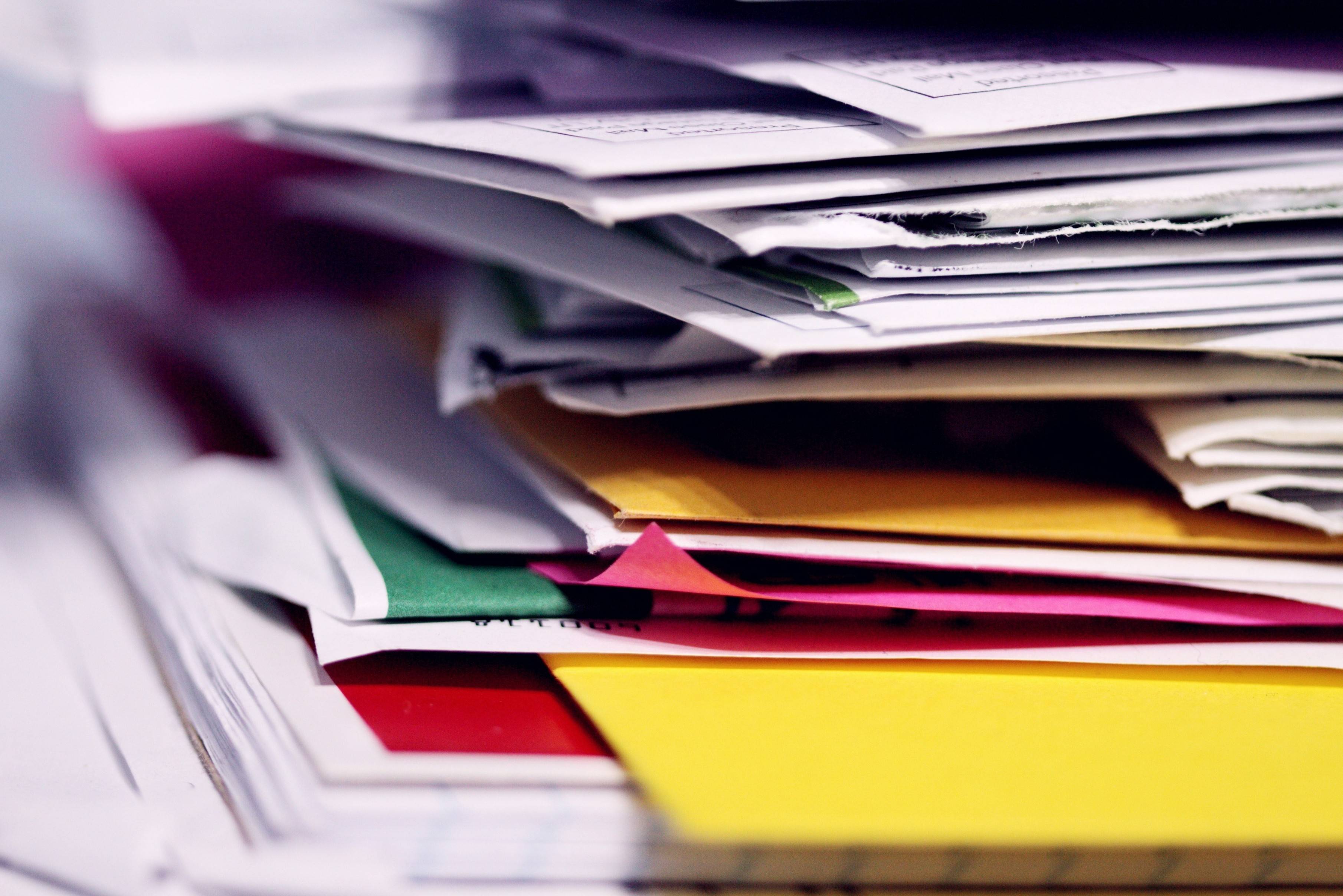 Stack of file folders with paper in them. 