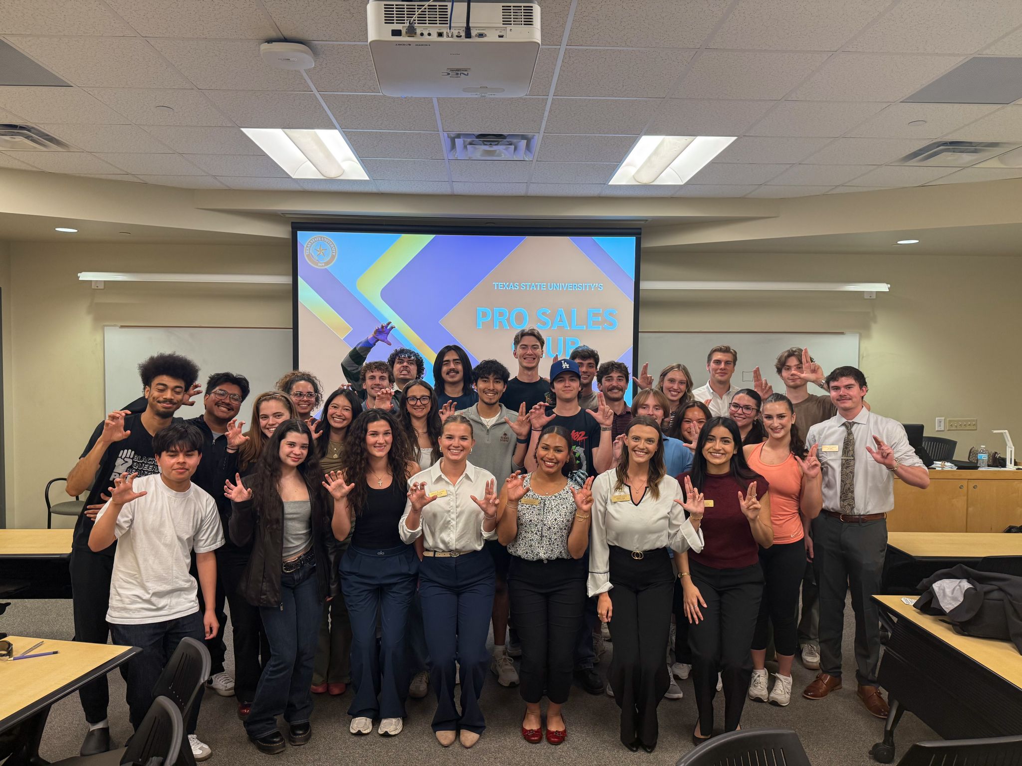 PRO Sales Club group photo with Texas State hand signs