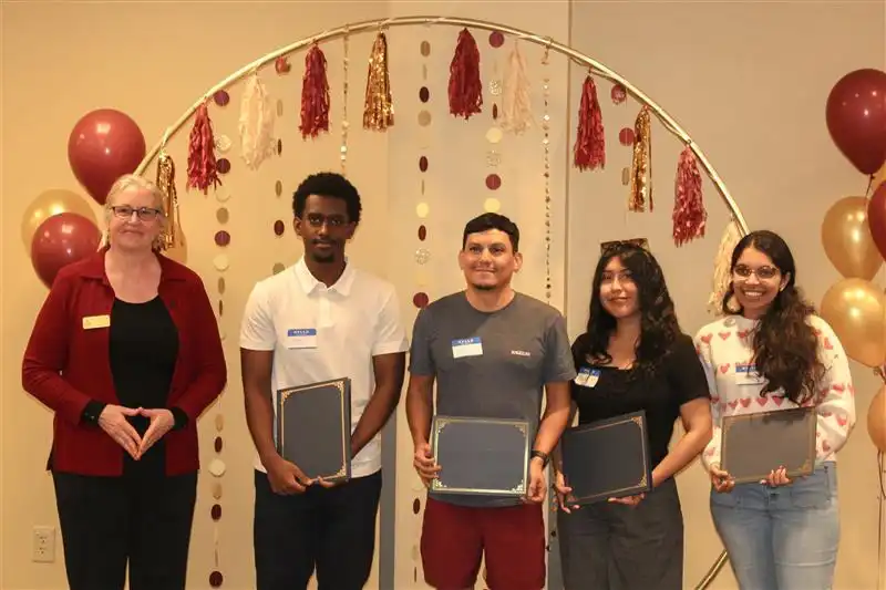 library directory handing out certificates to second place winner team NAND
