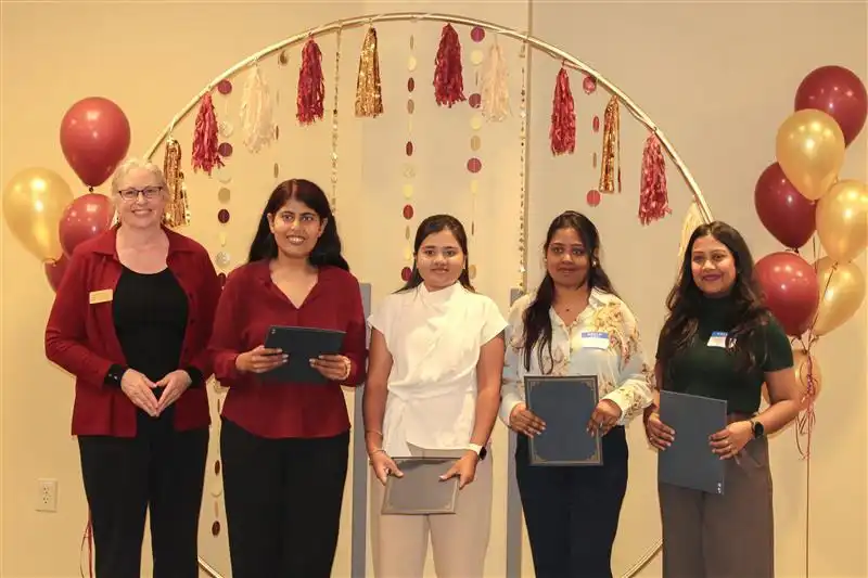 Library director handing out the certificate to the third place winner team Data Dominators