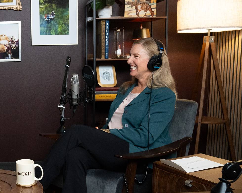 woman laughing while wearing headphones