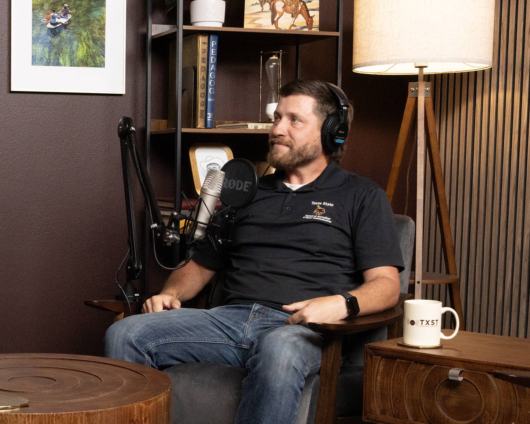 man wearing headphones while recording a podcast