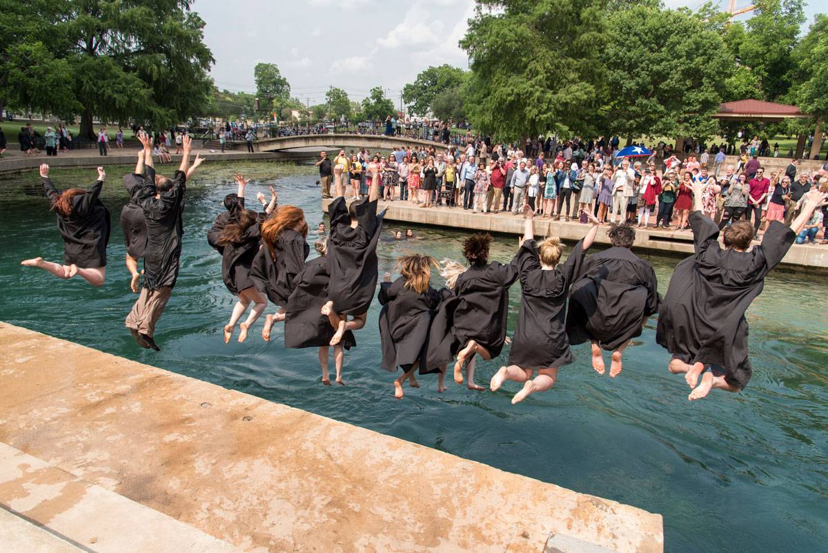 graduates jumping into river