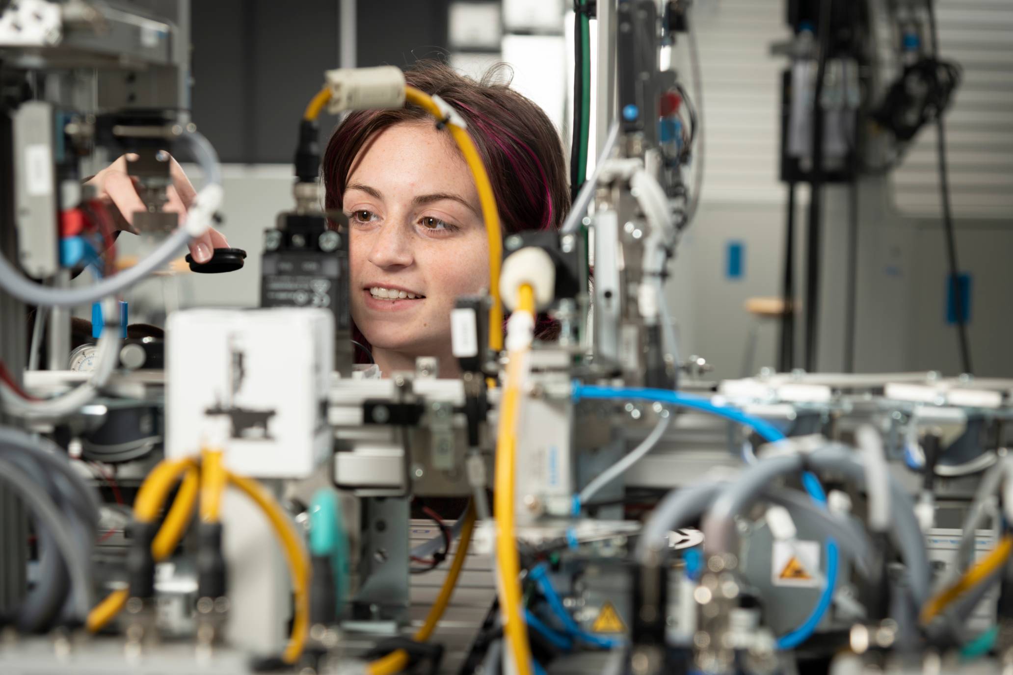 a student assembles electrical equipment