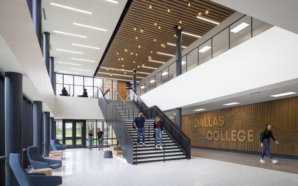 interior of campus building with students walking down stairs