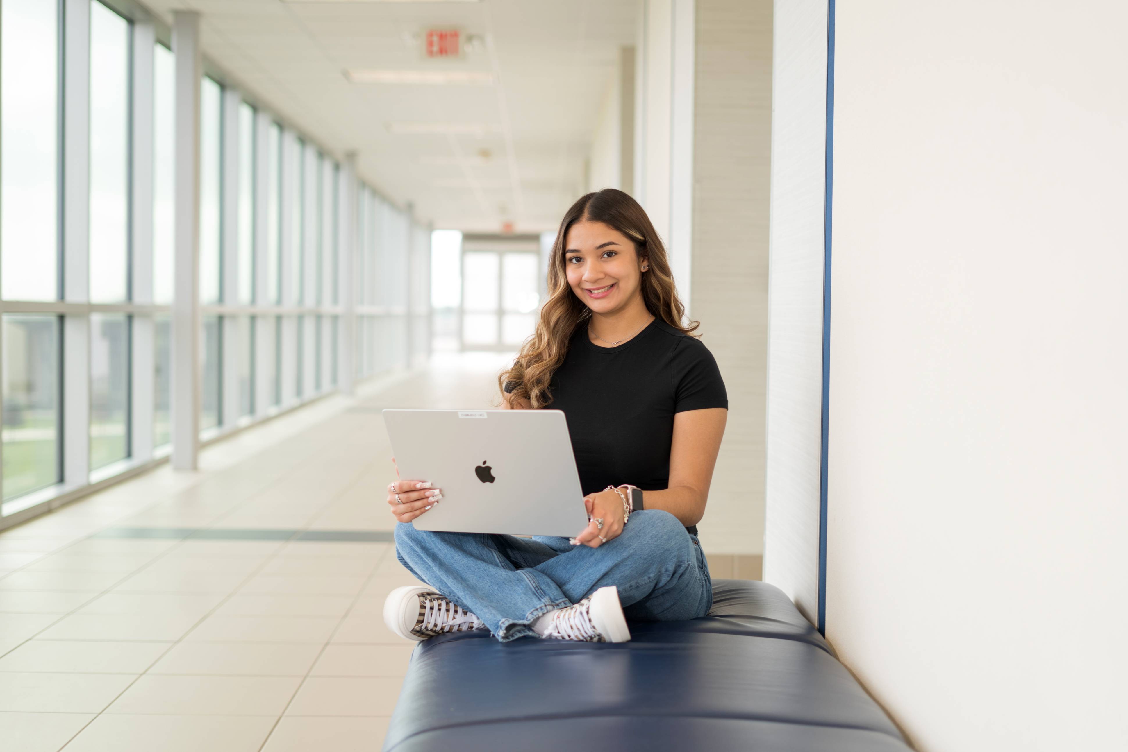 student smiling with laptop