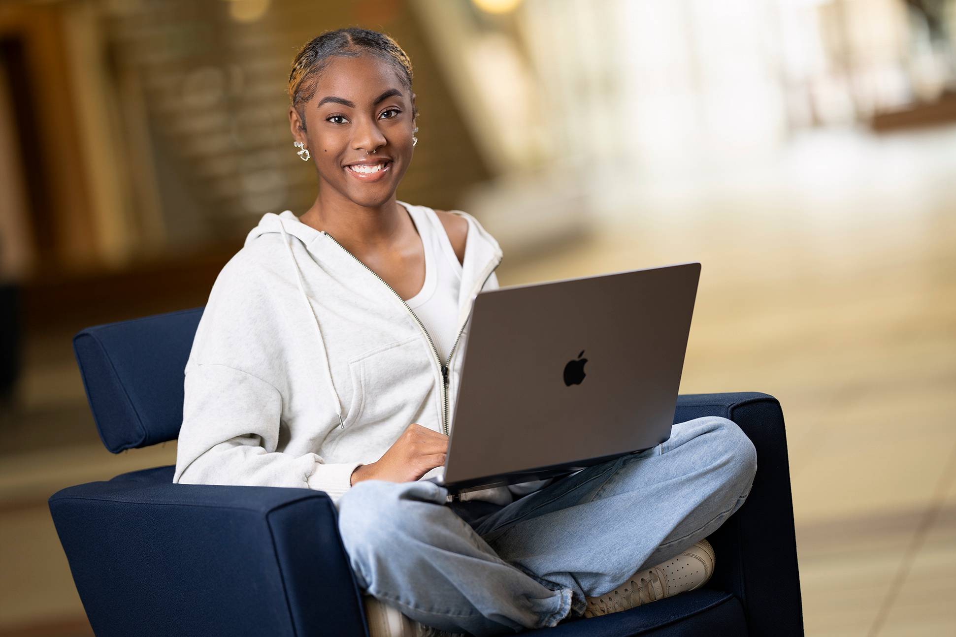 a student with a laptop in a chair