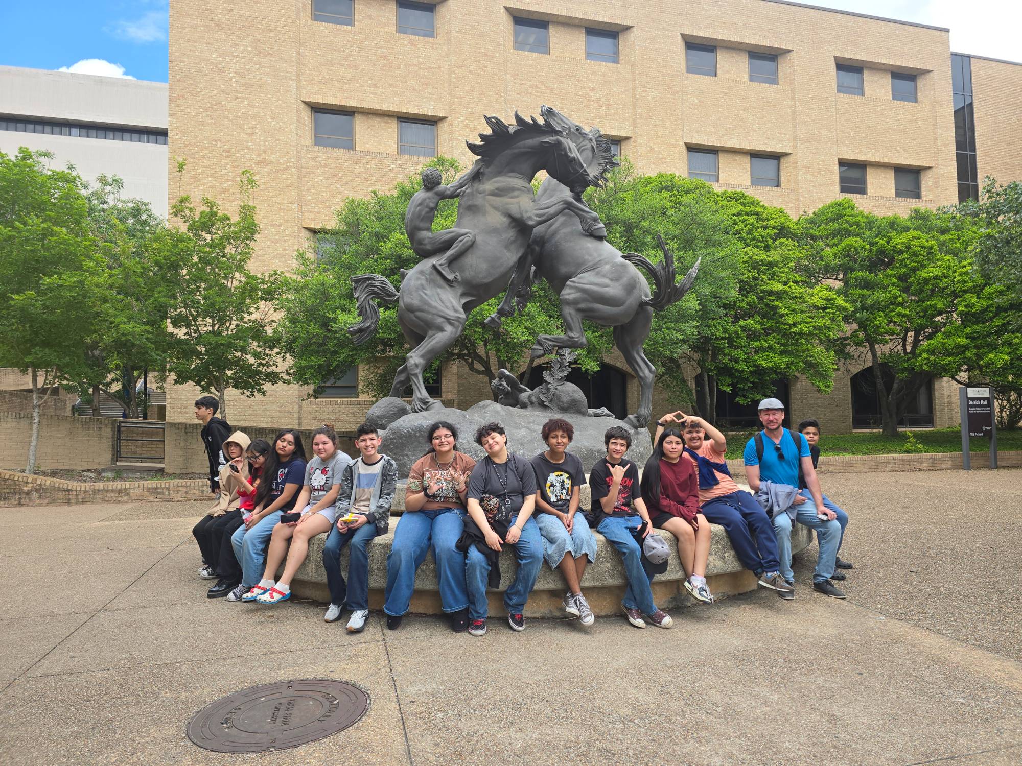Students at TXST Statue
