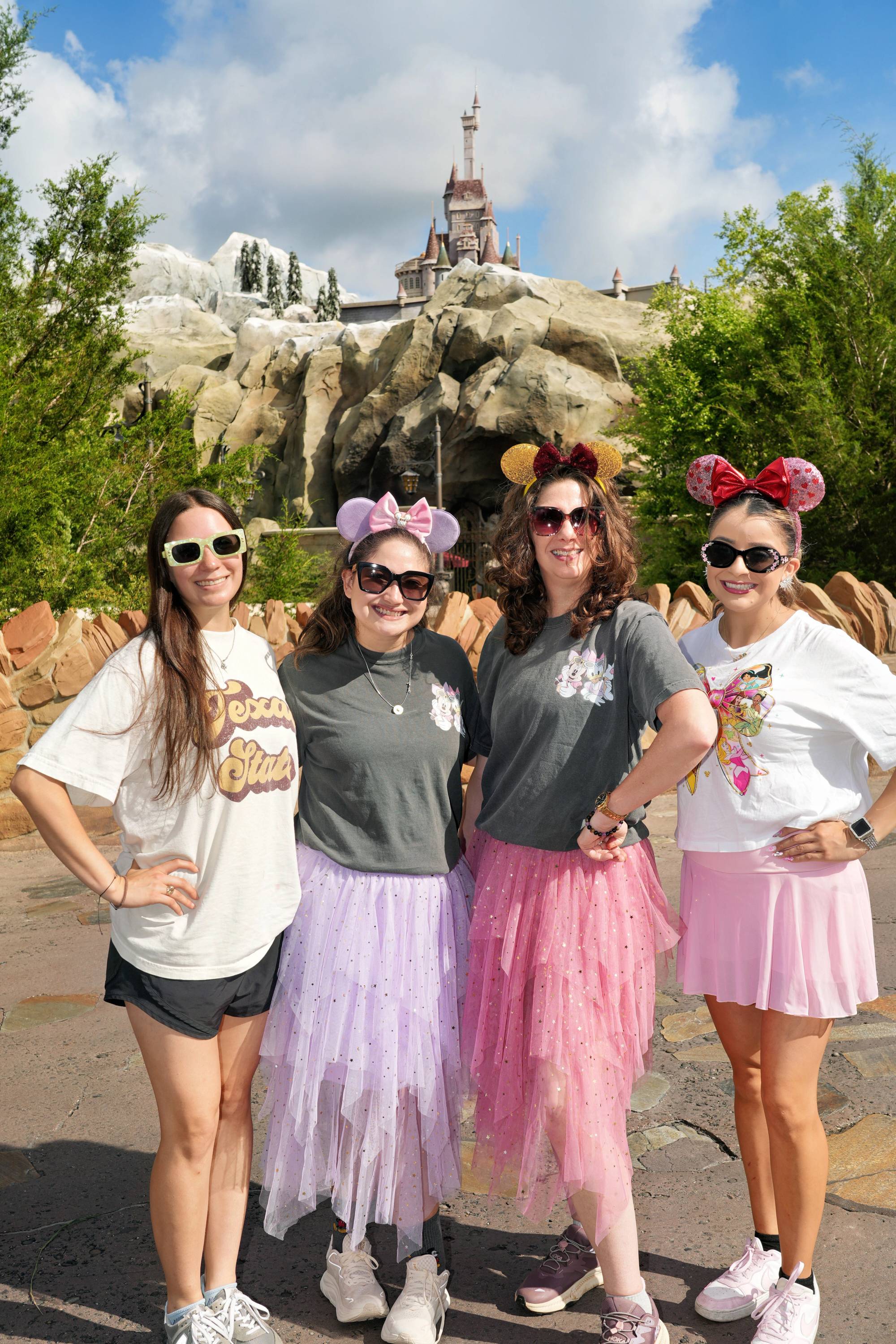 four women posing at disney world