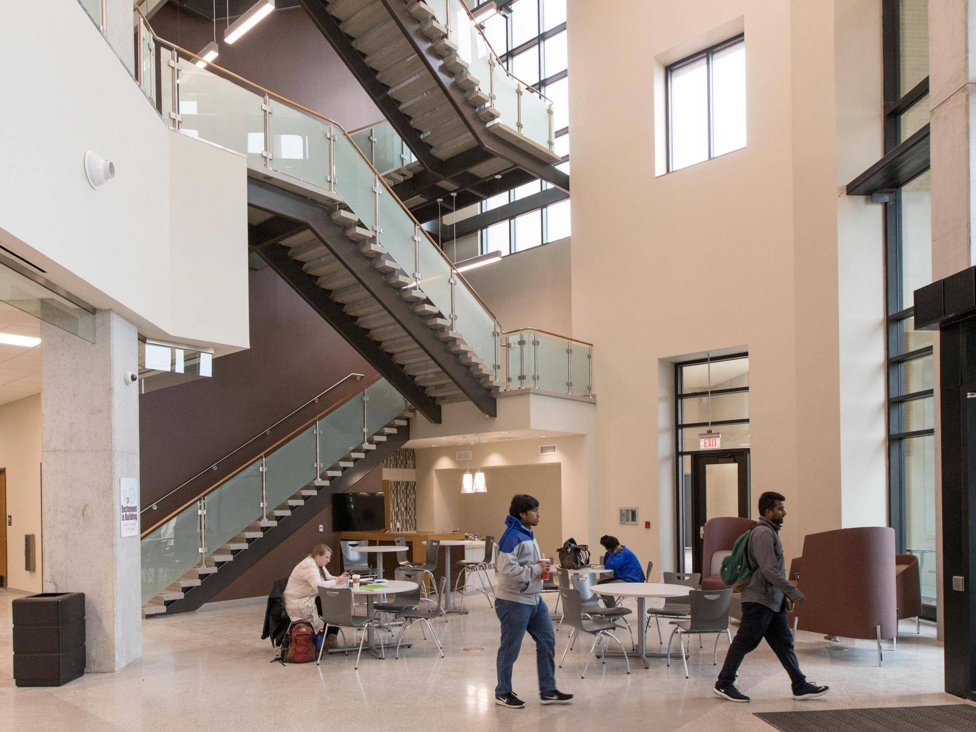 lobby of ingram hall with students walking through and sitting at tables