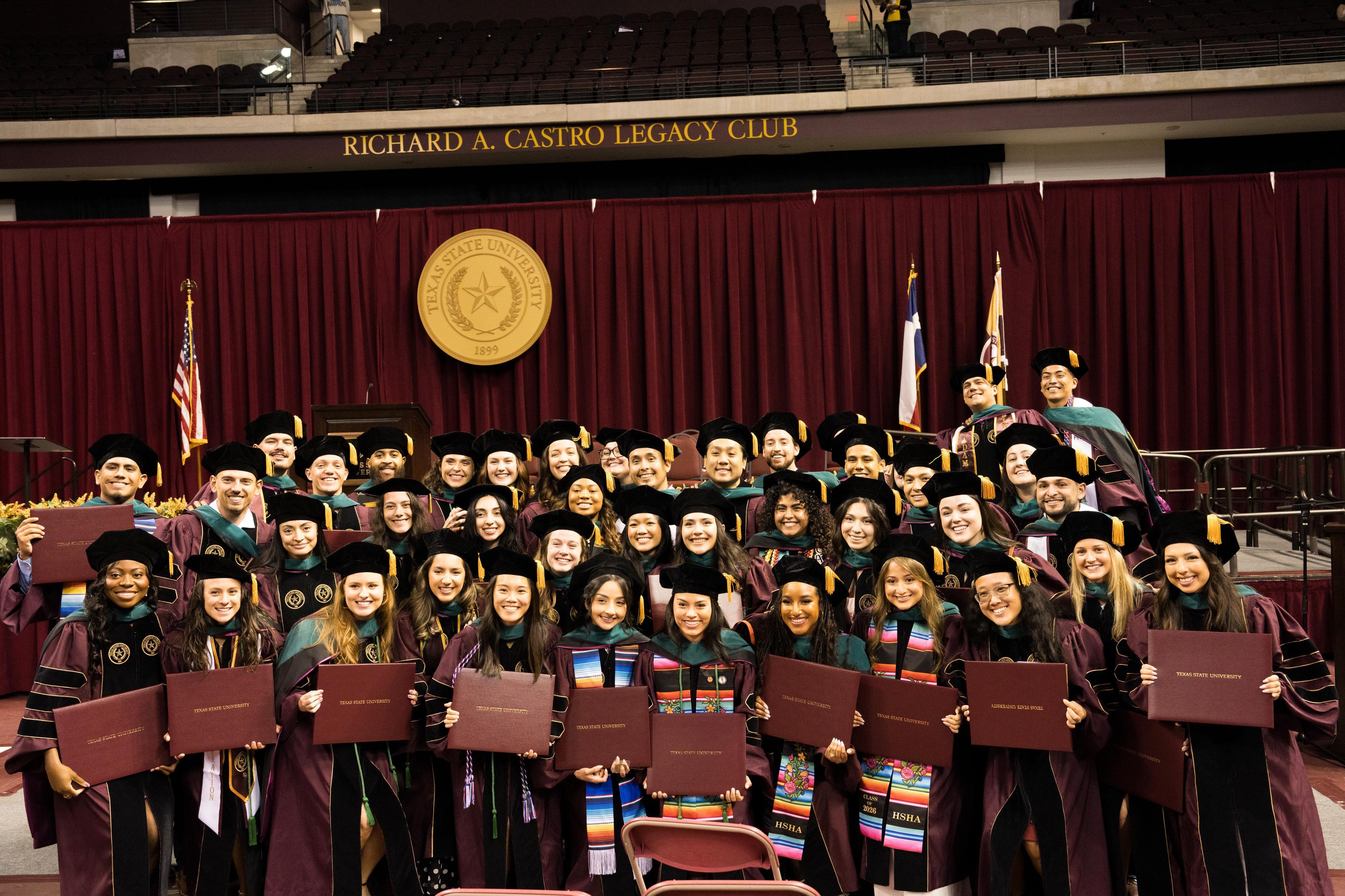 large group of doctoral graduates at commencement ceremony