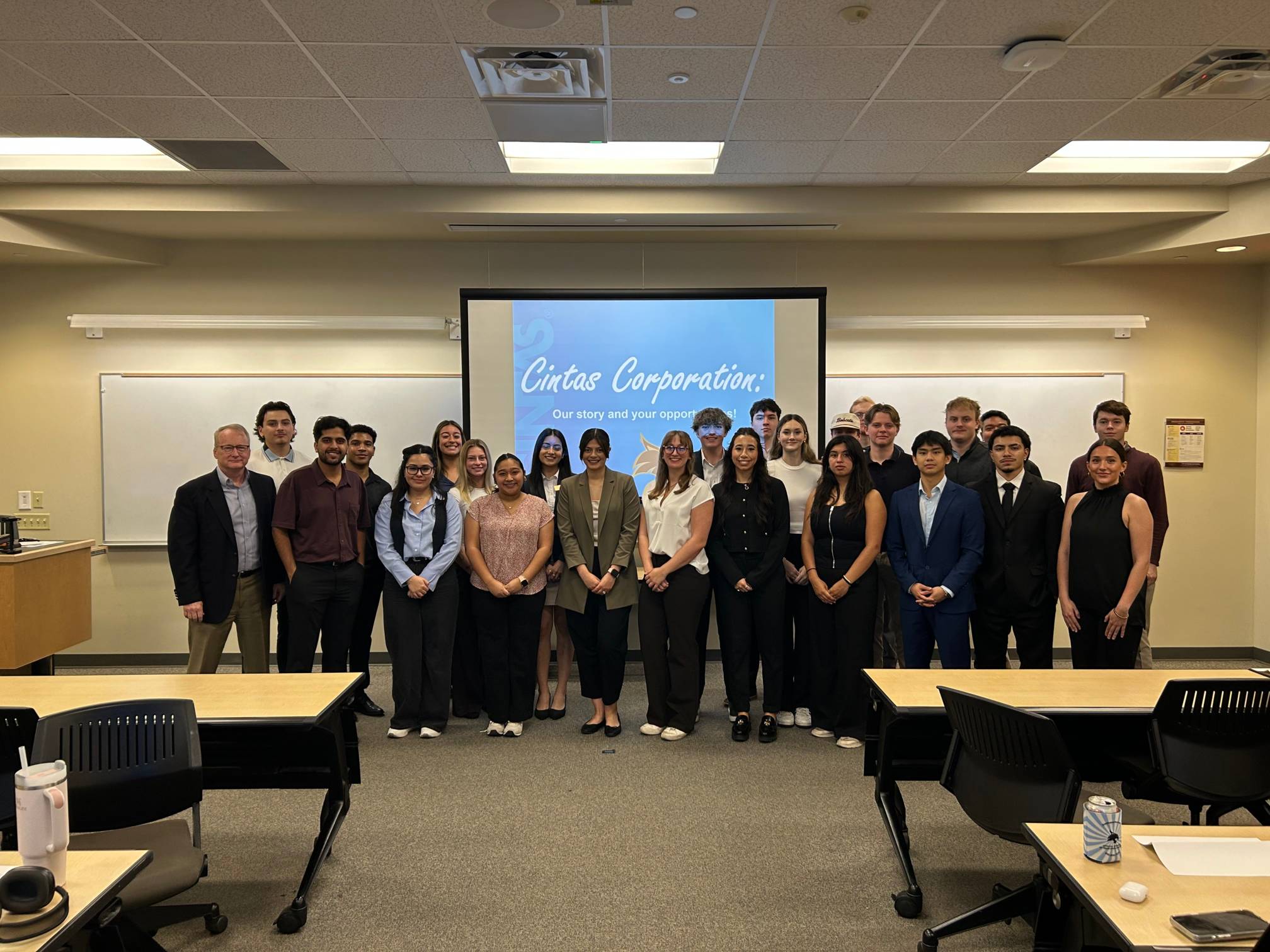 group of students in front of screen with Cintas