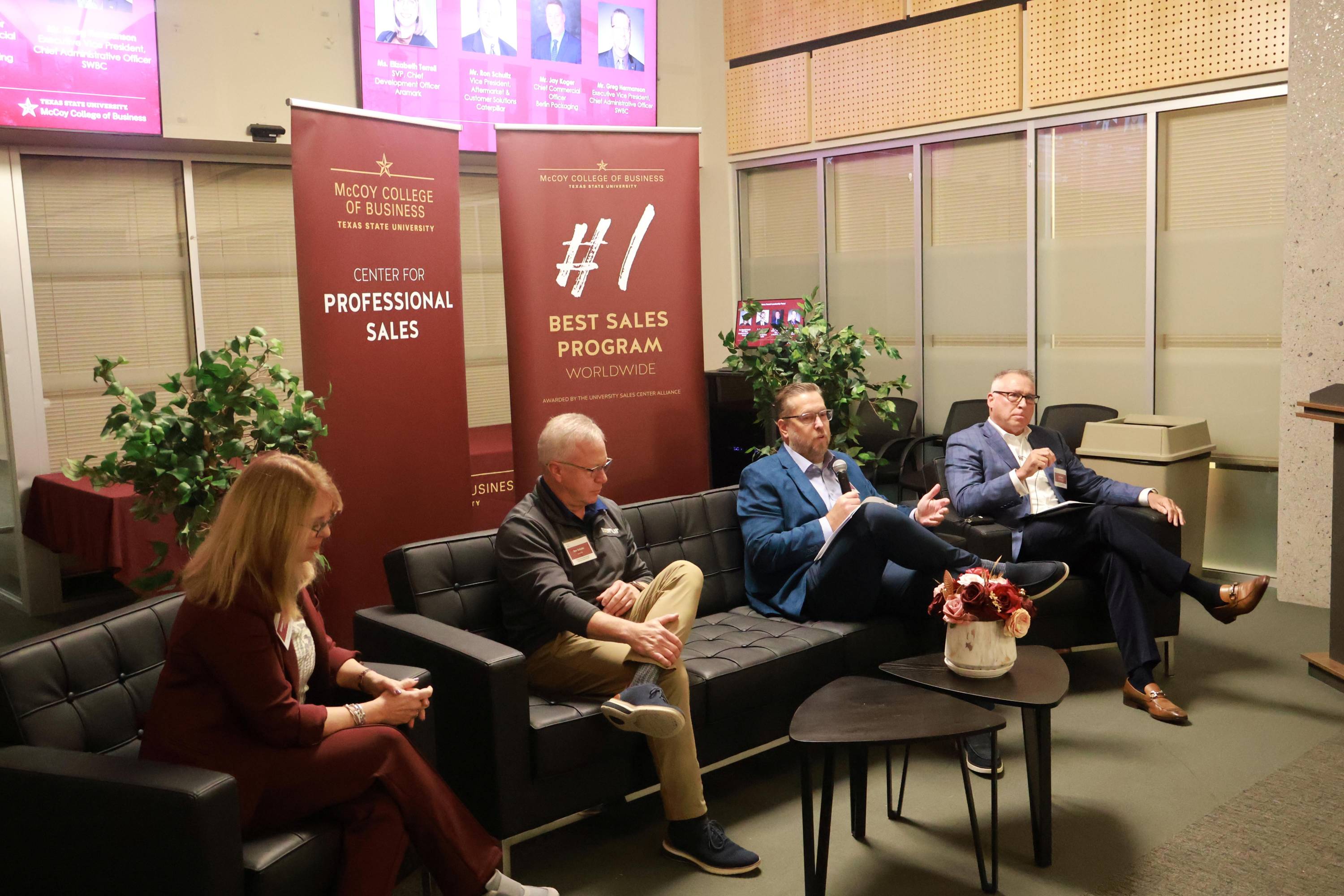 four executives sitting on couches