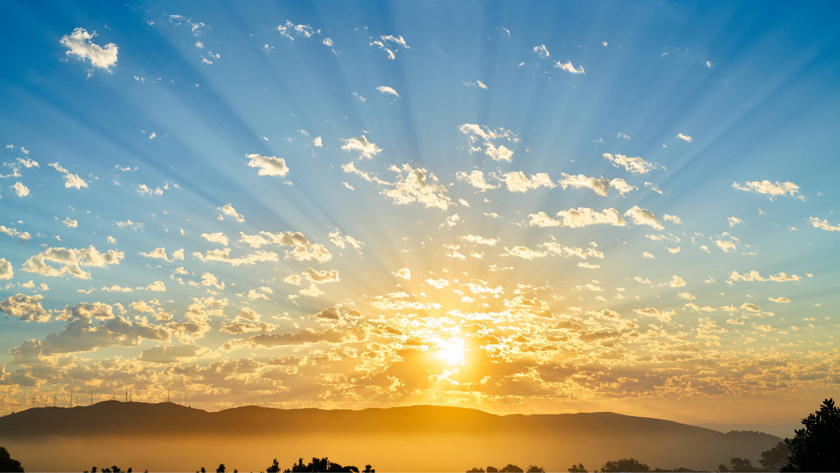 a sunrise over hills