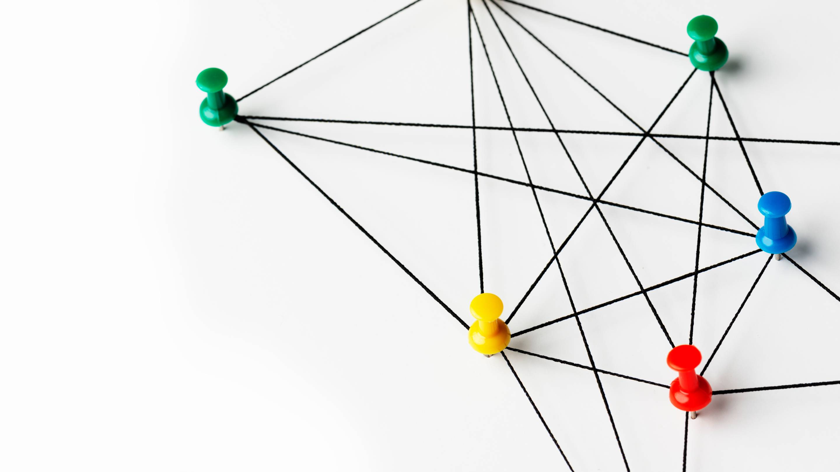 string attached to pins on wall