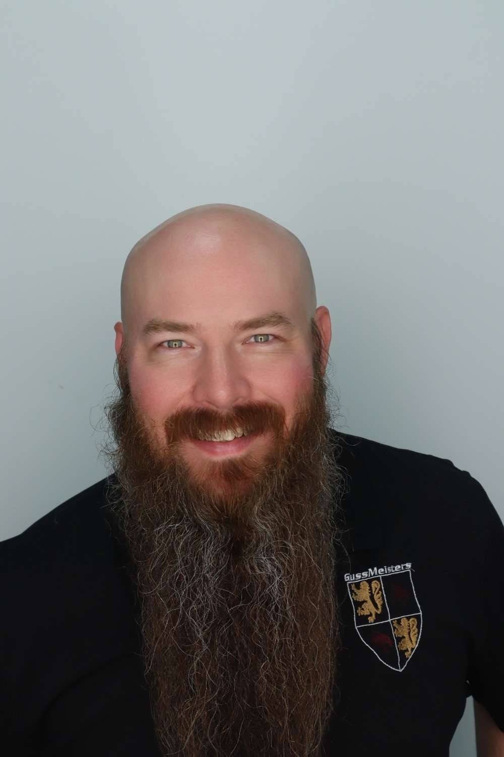 photo of Communications Officer George Brown smiling wearing a black shirt
