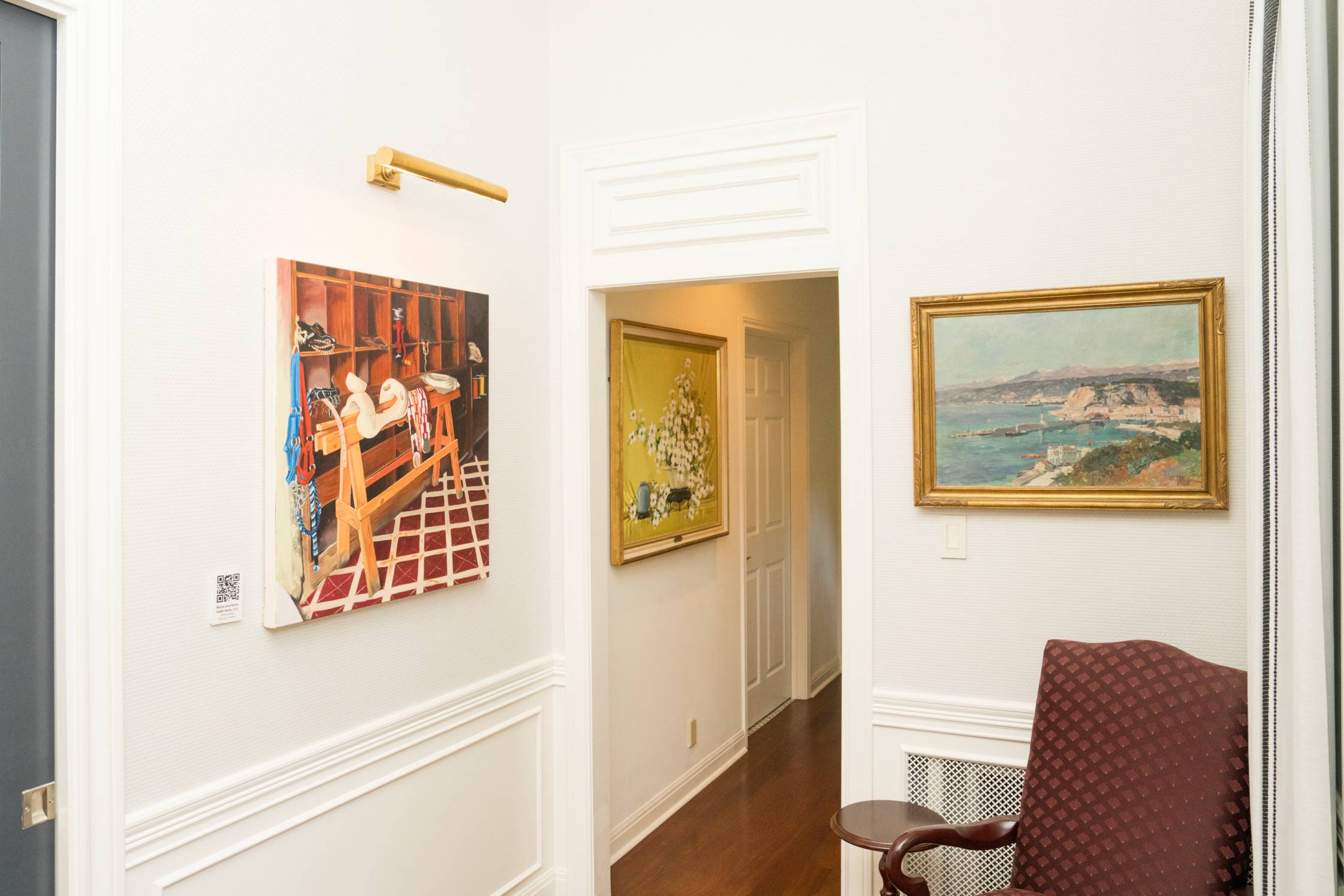 foyer of home with three paintings hanging on white walls