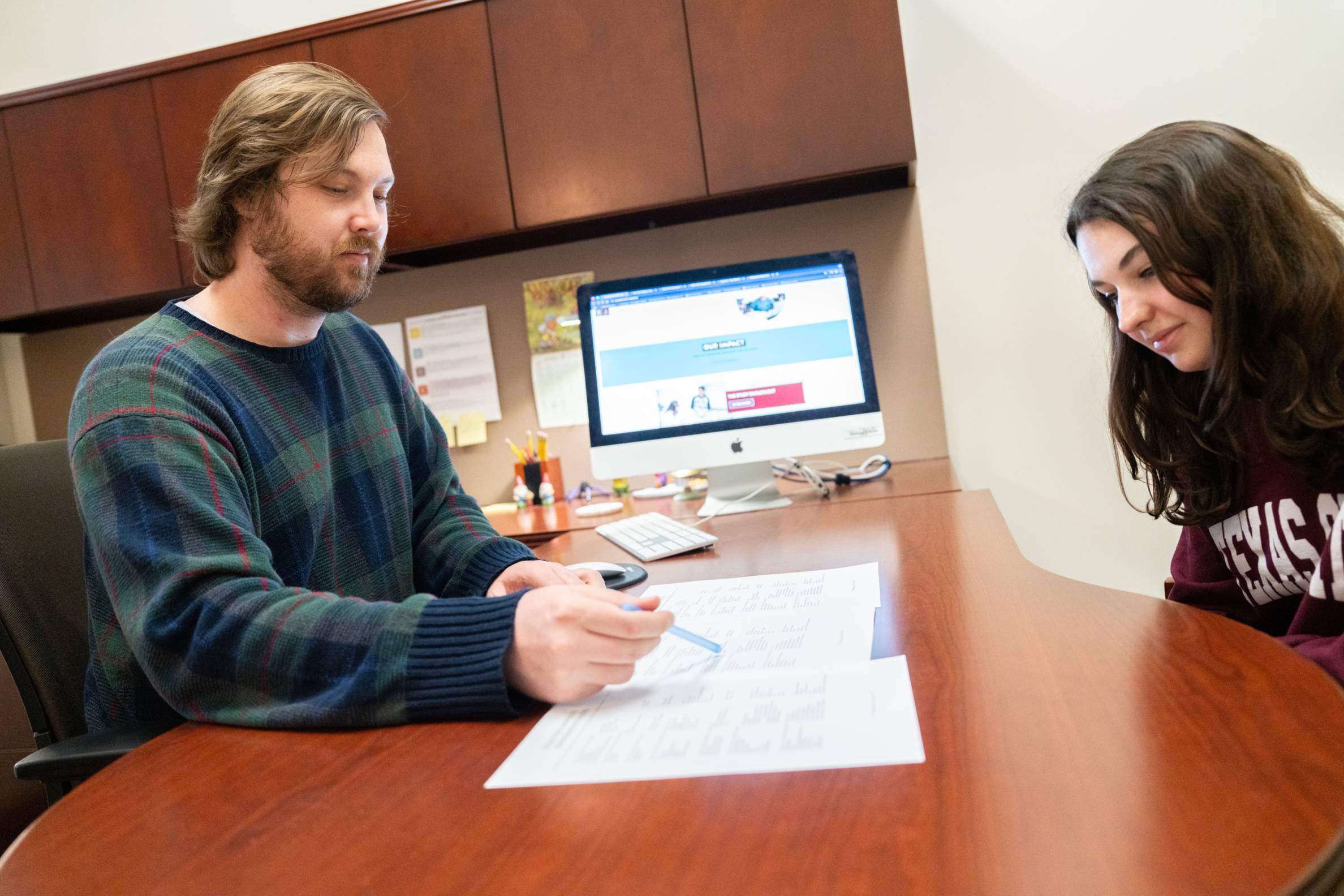 Student sitting at a desk being advised