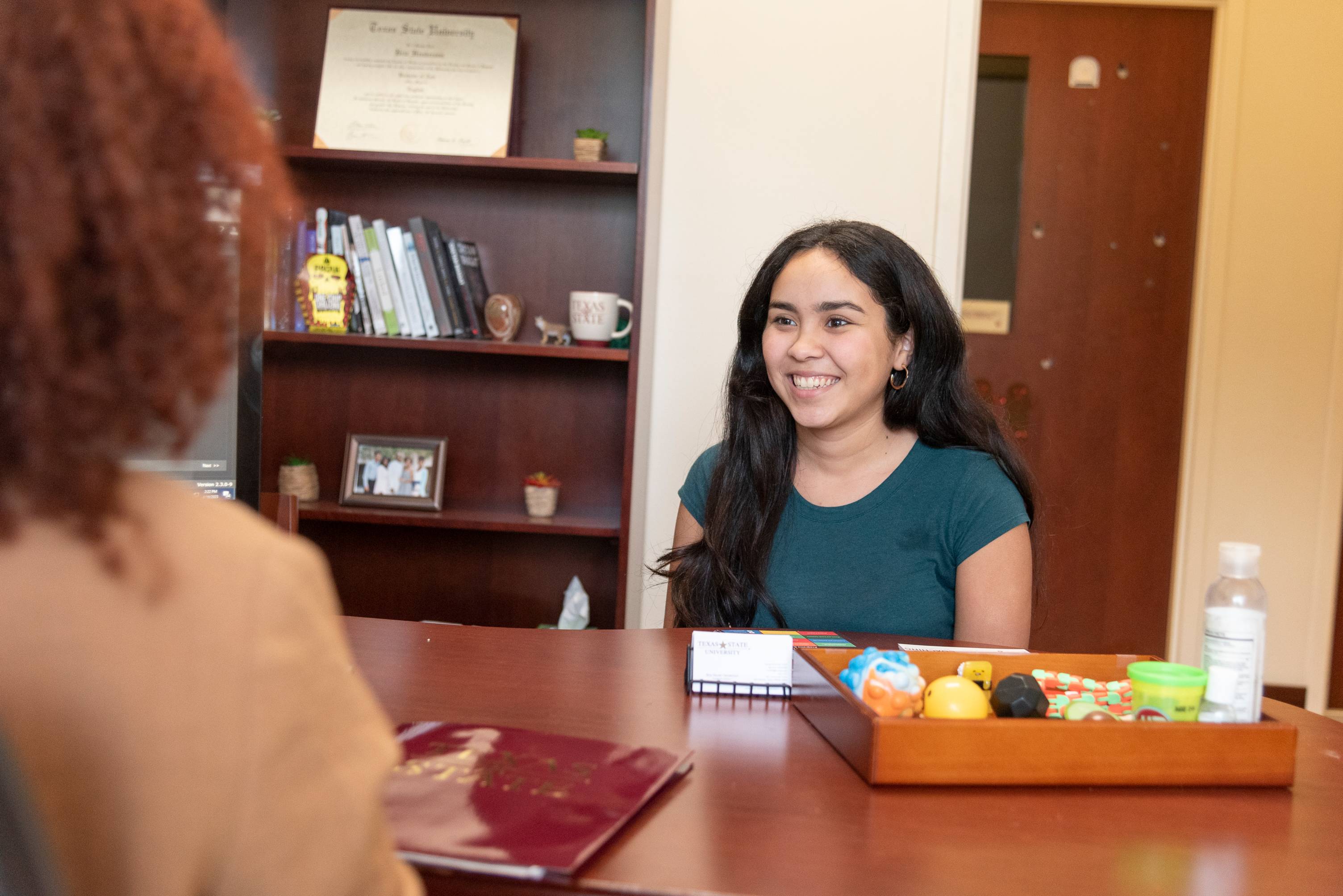 Student sitting at a desk being advised