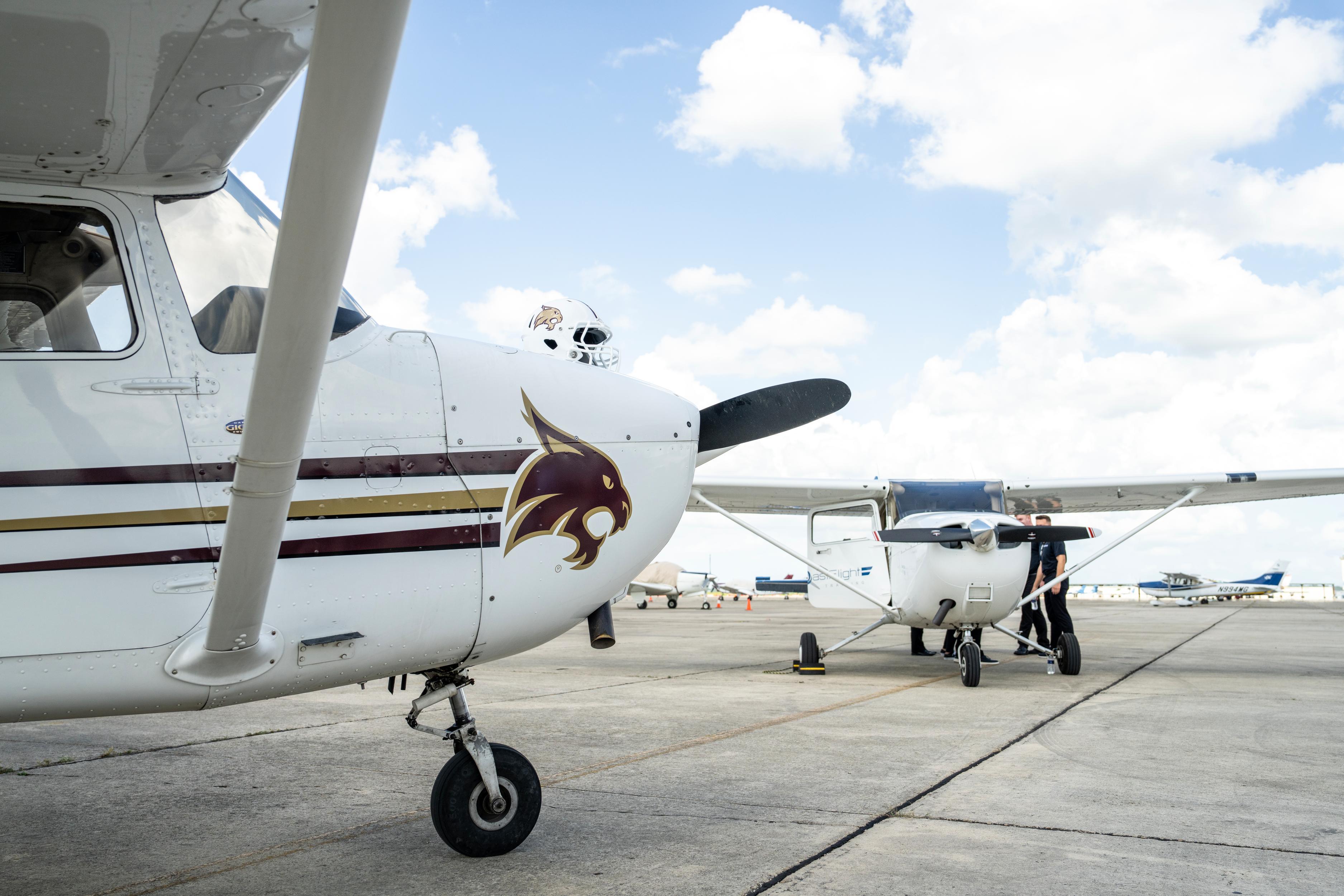 two small white planes on tarmac