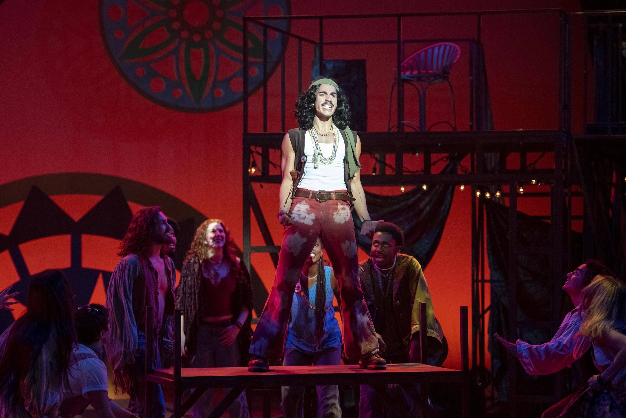 Student performers on stage during a production of Hair.