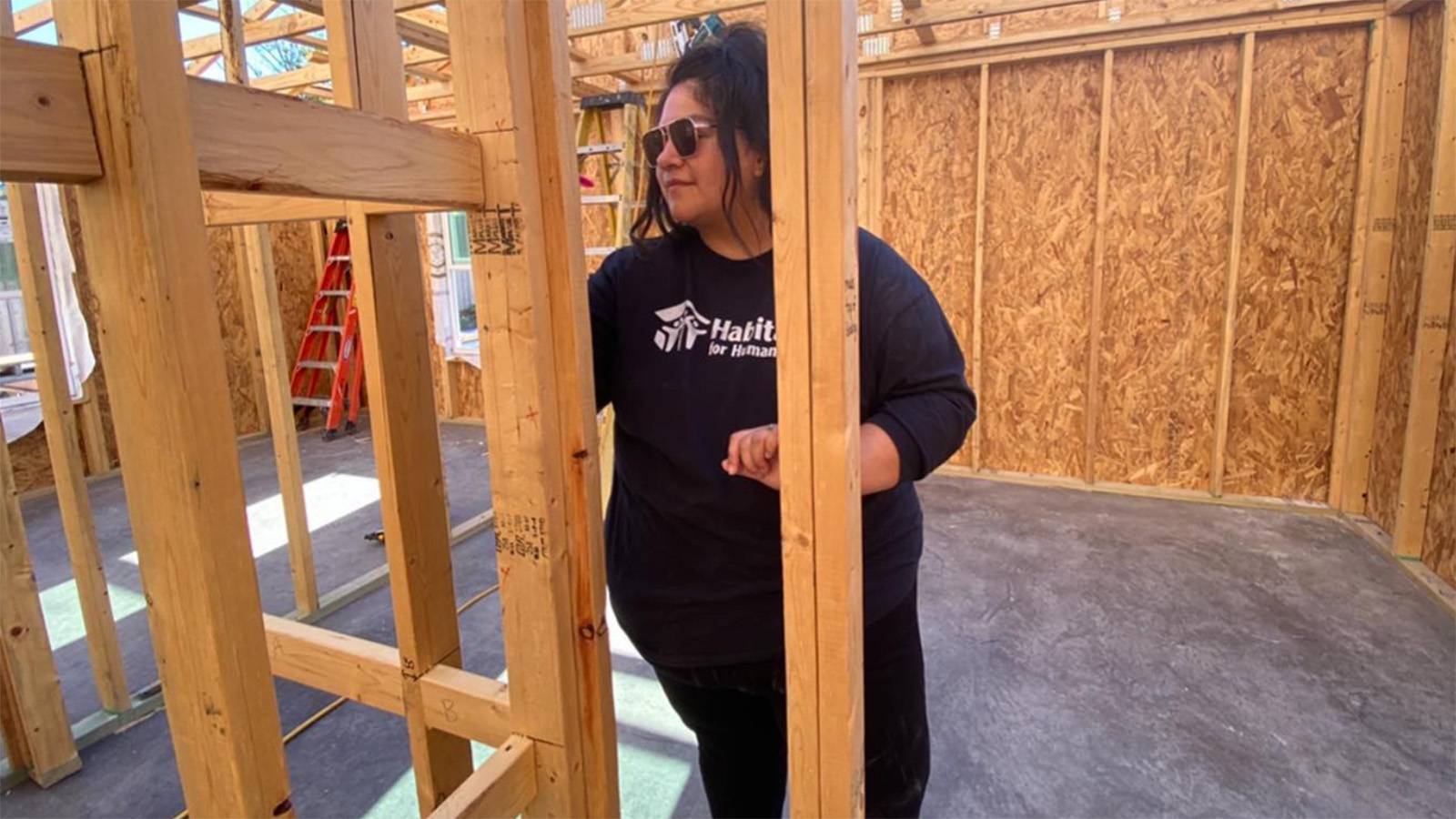 Woman standing inside a home under construction