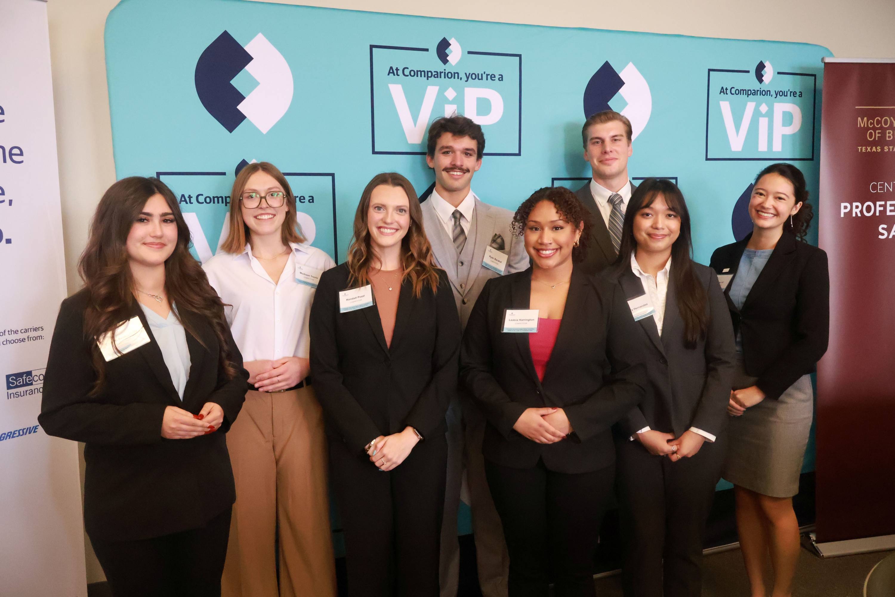 eight students in front of a comparion banner
