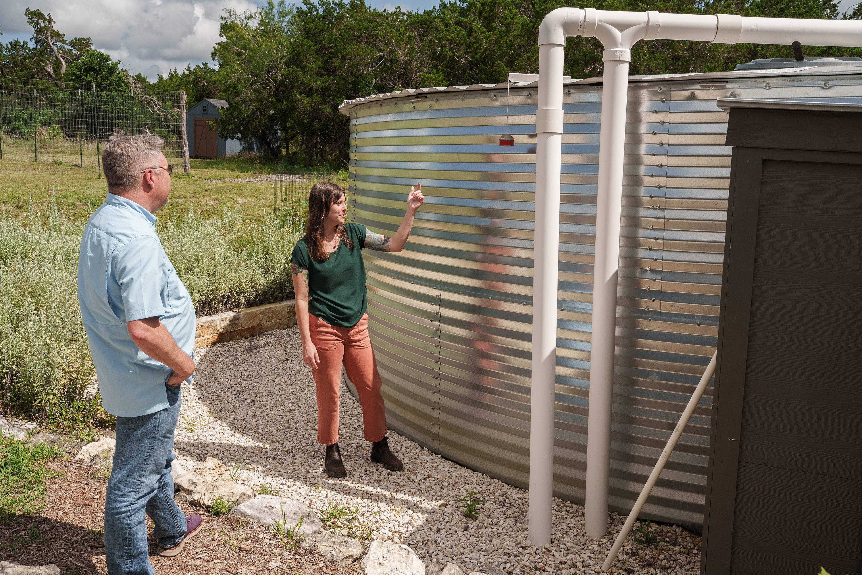 Dr. Robert Mace and Katie Tritsch look at a gauge that shows the water level in the collection tank.