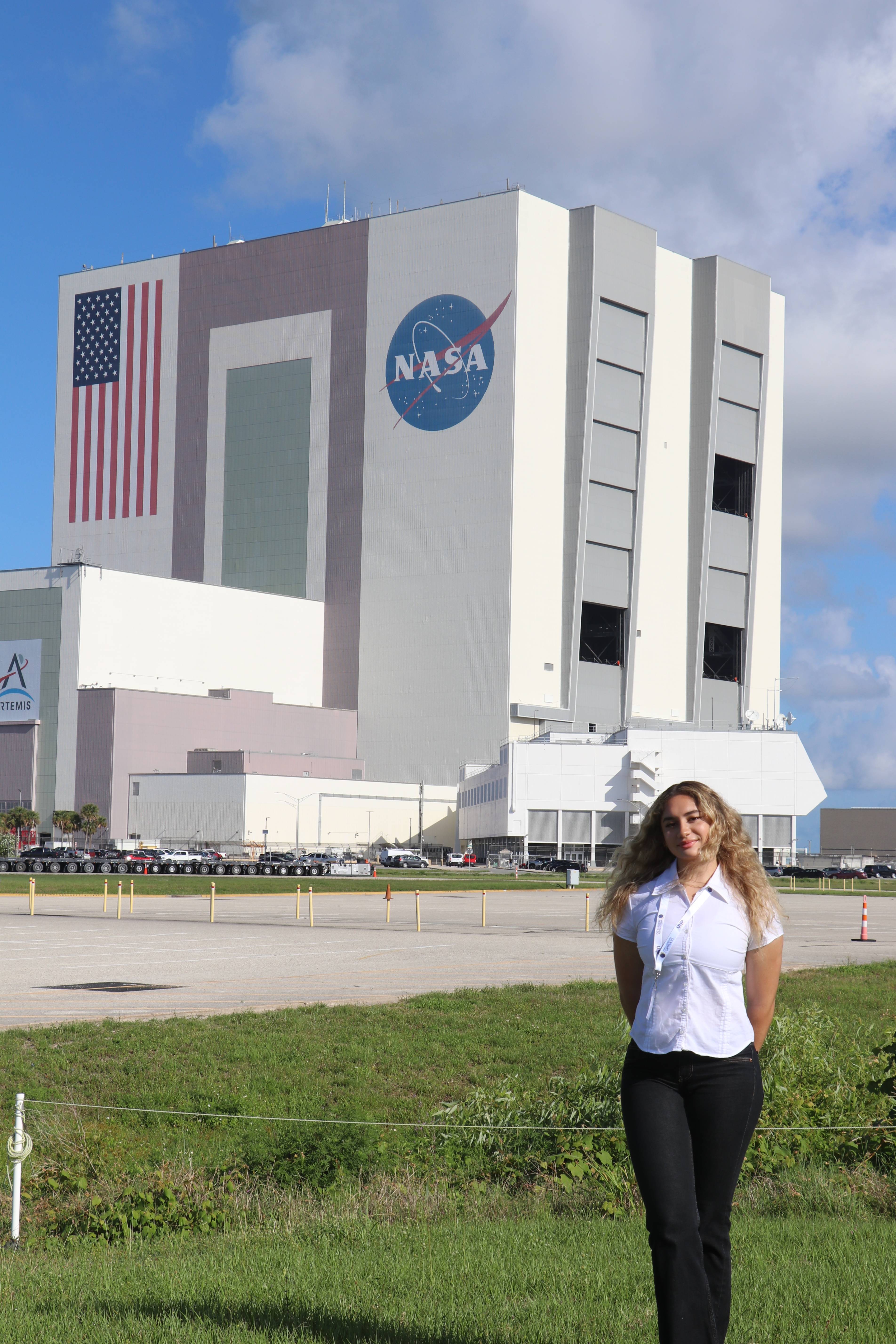 woman standing outside large NASA building