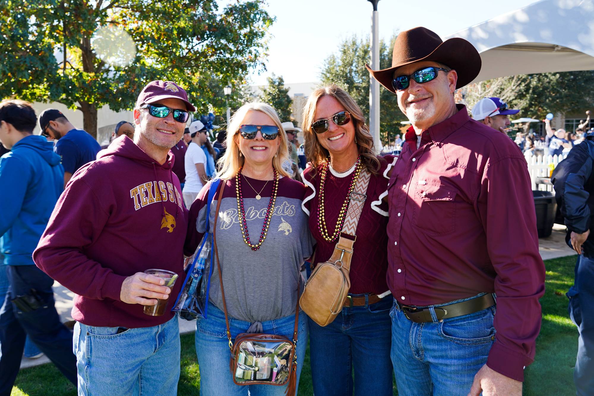 Group of Texas State fans tailgating on a green space
