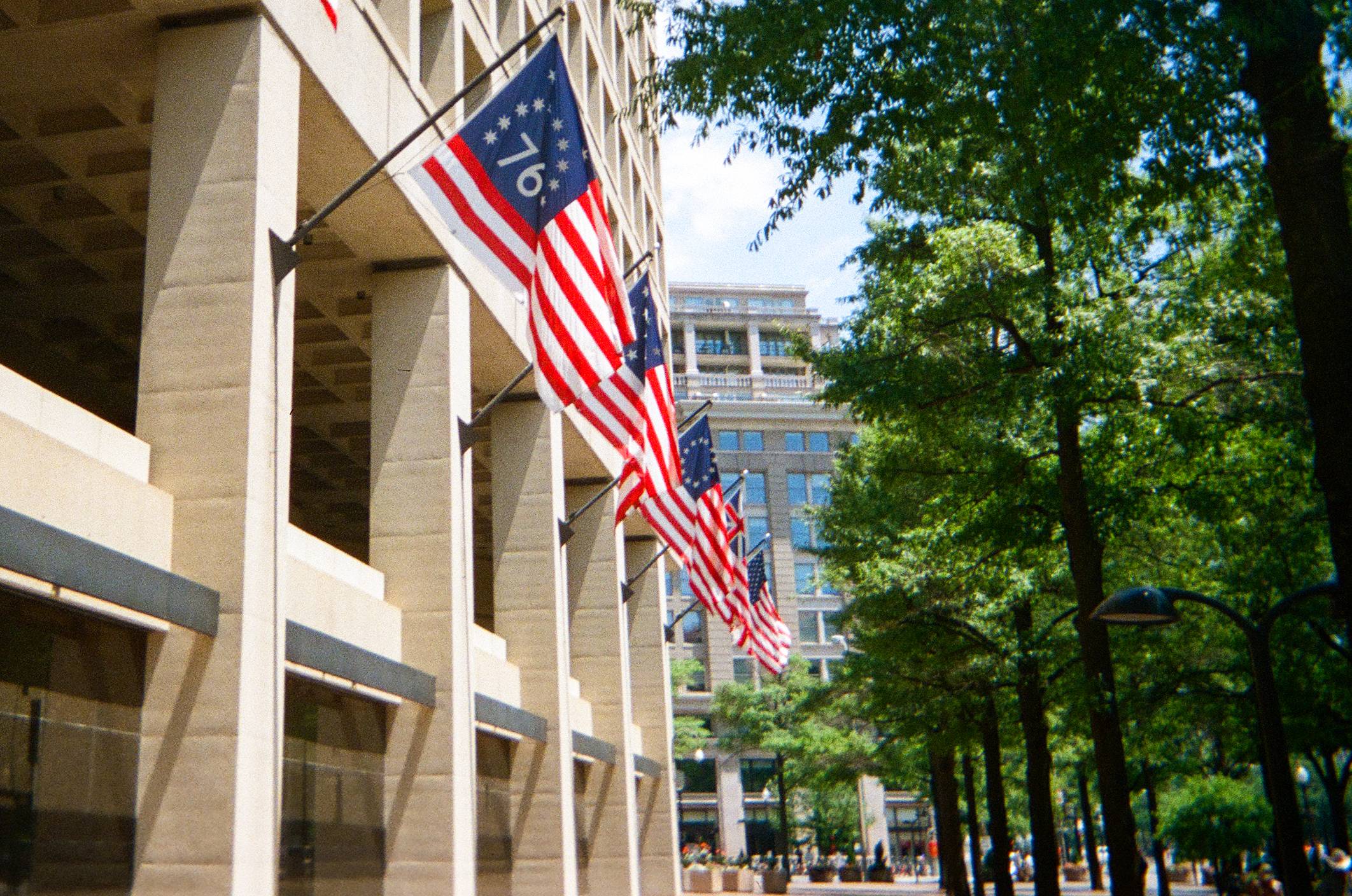 american flags hang on the side of a building
