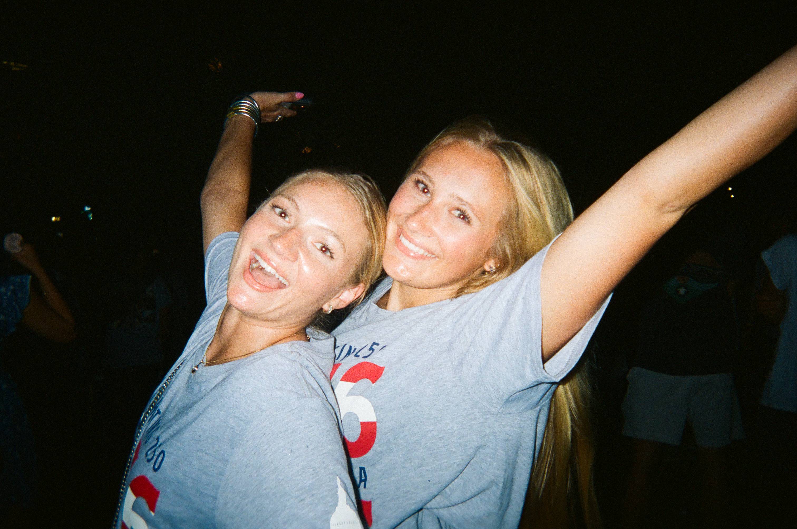 two female students cheer for a photo
